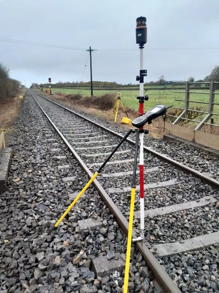 Executing high-risk infrastructure surveying using a total station on a live railway track.